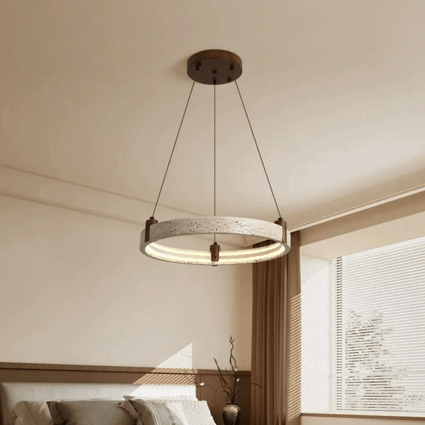 Modern pendant light hanging in a room with neutral walls and a window.