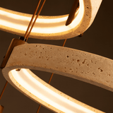Close-up of a modern light fixture with concrete-like design on a dark background