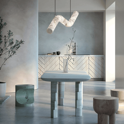 Modern interior with a marble table and geometric pendant light.