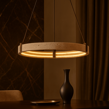 Modern pendant light hanging above a table with a vase and plate in a warm-toned room.