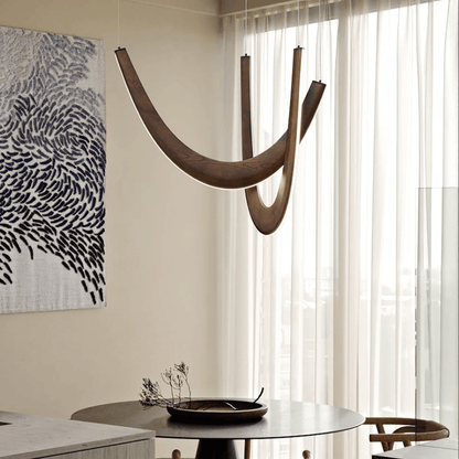 Modern interior with a hanging wooden sculpture, round table, and abstract art on the wall.