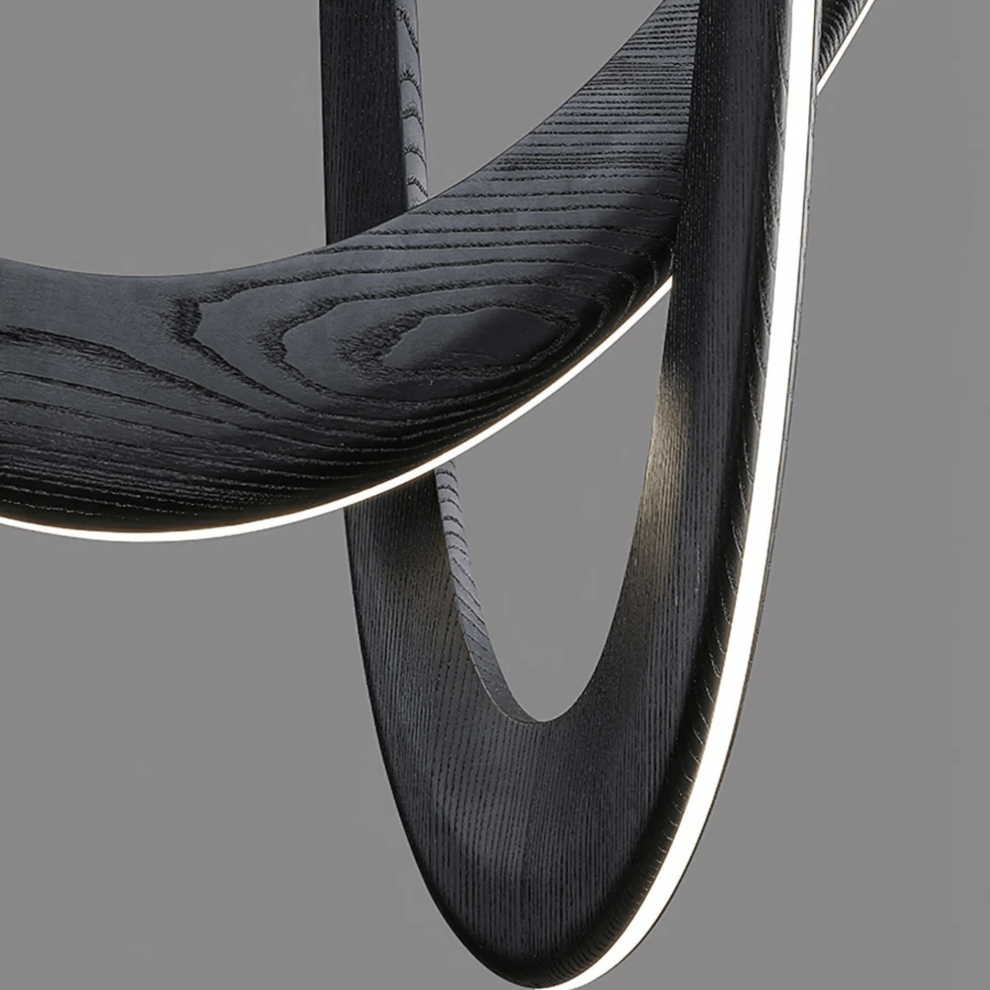 Close-up of a black wooden chair with a gray background
