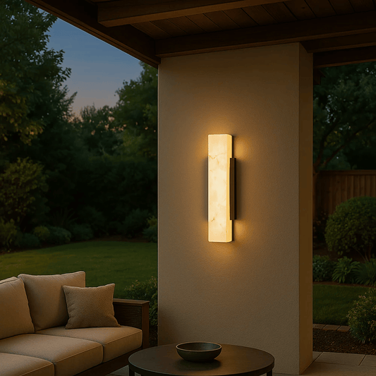 Outdoor wall light fixture on a house exterior with a garden view