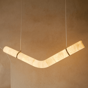 Modern pendant light fixture on a beige wall