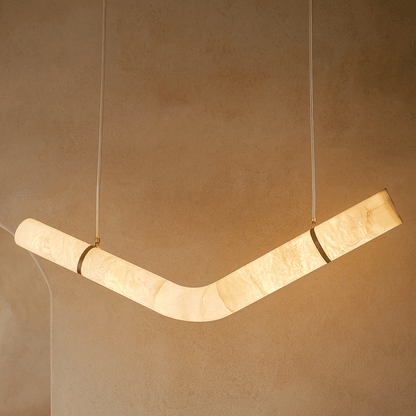 Modern pendant light fixture on a beige wall