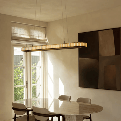 Modern dining room with a table, chairs, and a pendant light fixture.