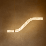 Modern pendant light with a curved design on a brown background