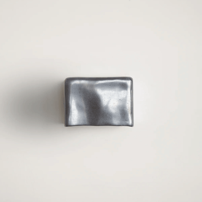 Metallic silver wallet on a light gray background