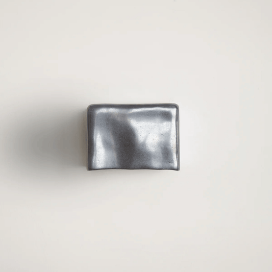 Metallic silver wallet on a light gray background