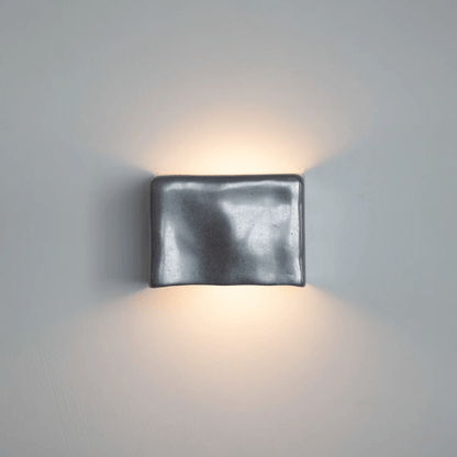 Square wall light fixture on a gray wall
