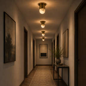 Long hallway with decorative lighting and framed artwork on the walls.