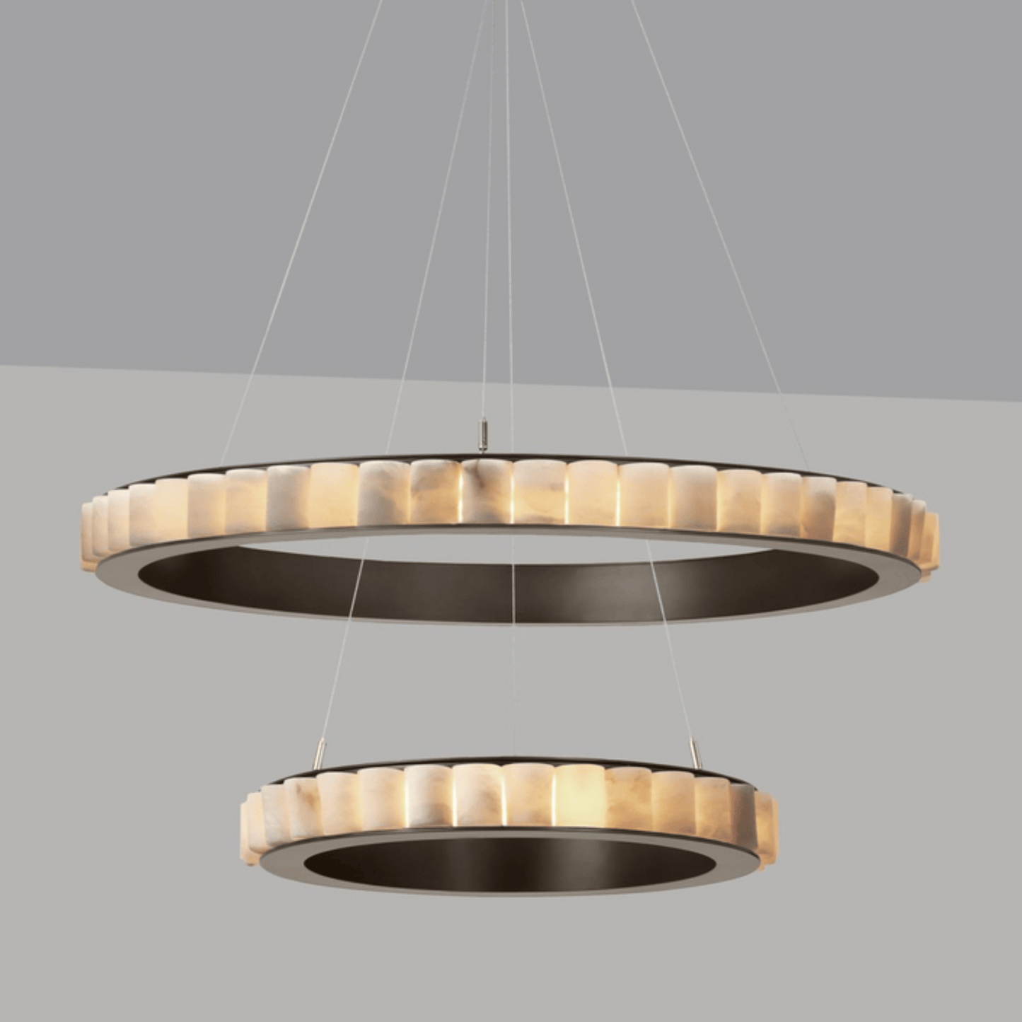 Modern pendant light with two circular designs on a gray background