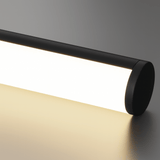 Black cylindrical light fixture on a neutral background