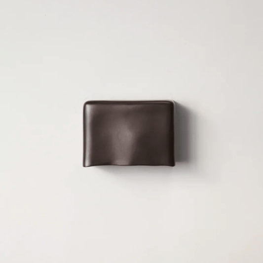Brown leather wallet on a light gray background