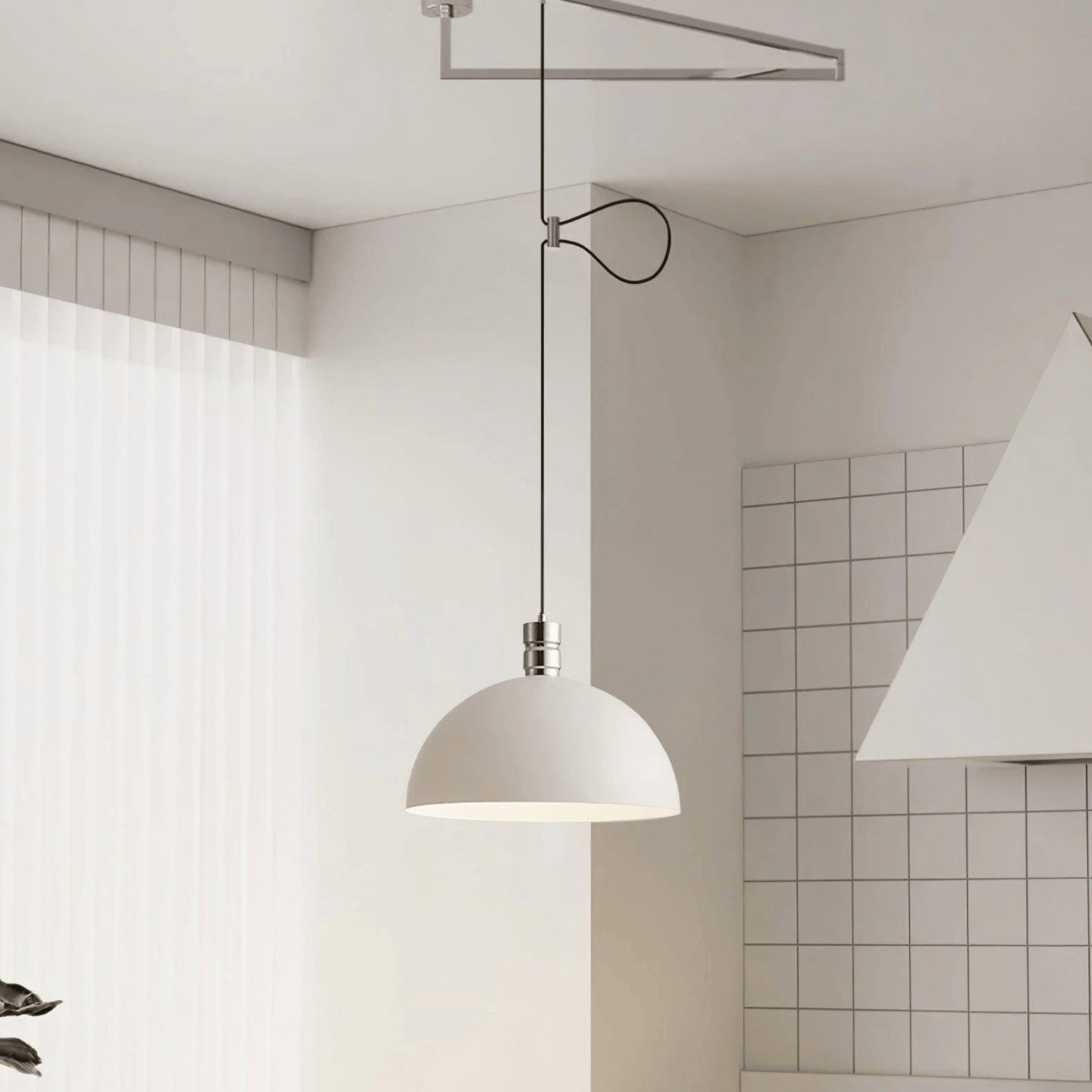 Modern pendant light hanging in a minimalistic room with tiled walls.