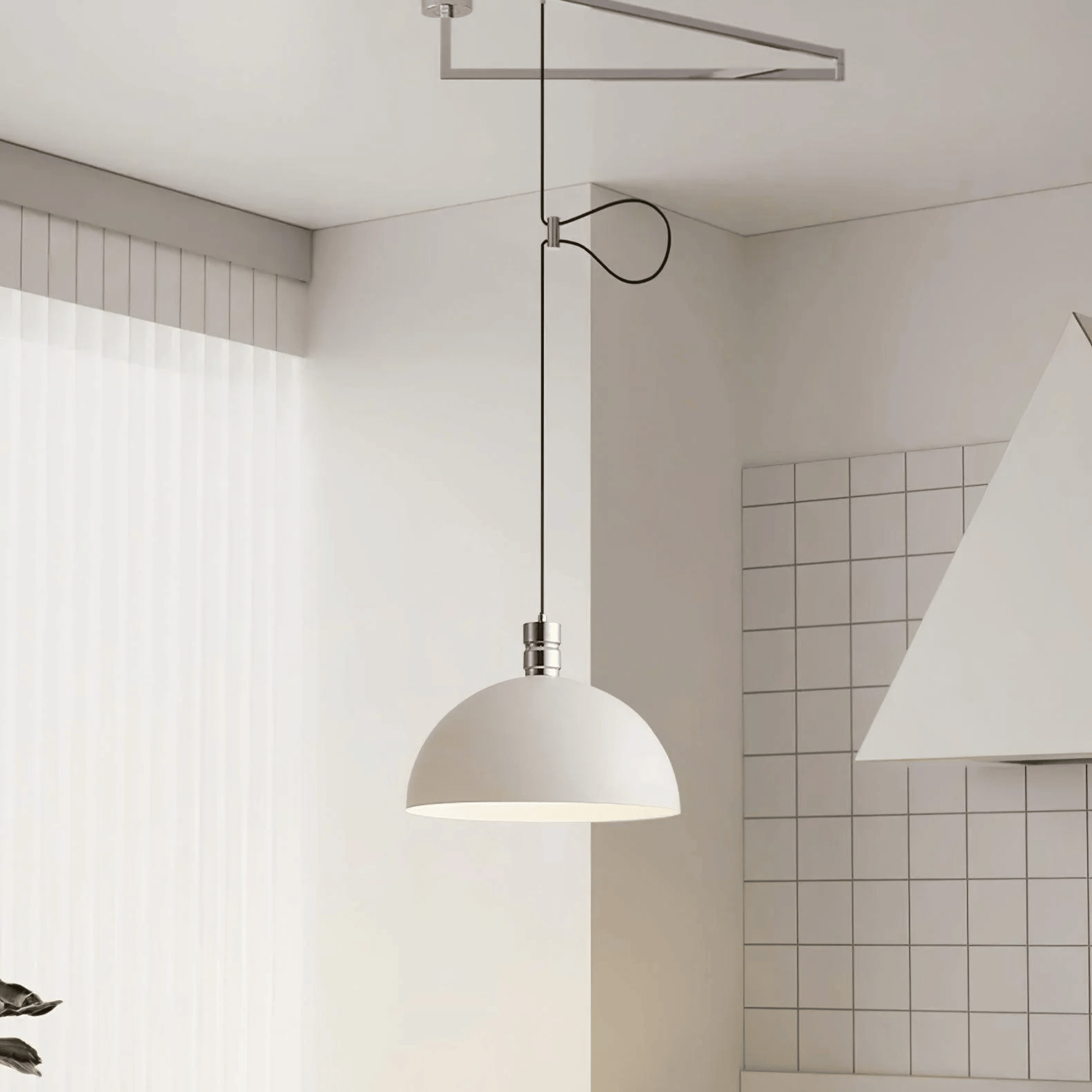 Modern pendant light hanging in a minimalistic room with tiled walls.