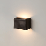 Black square wall light fixture on a gray wall