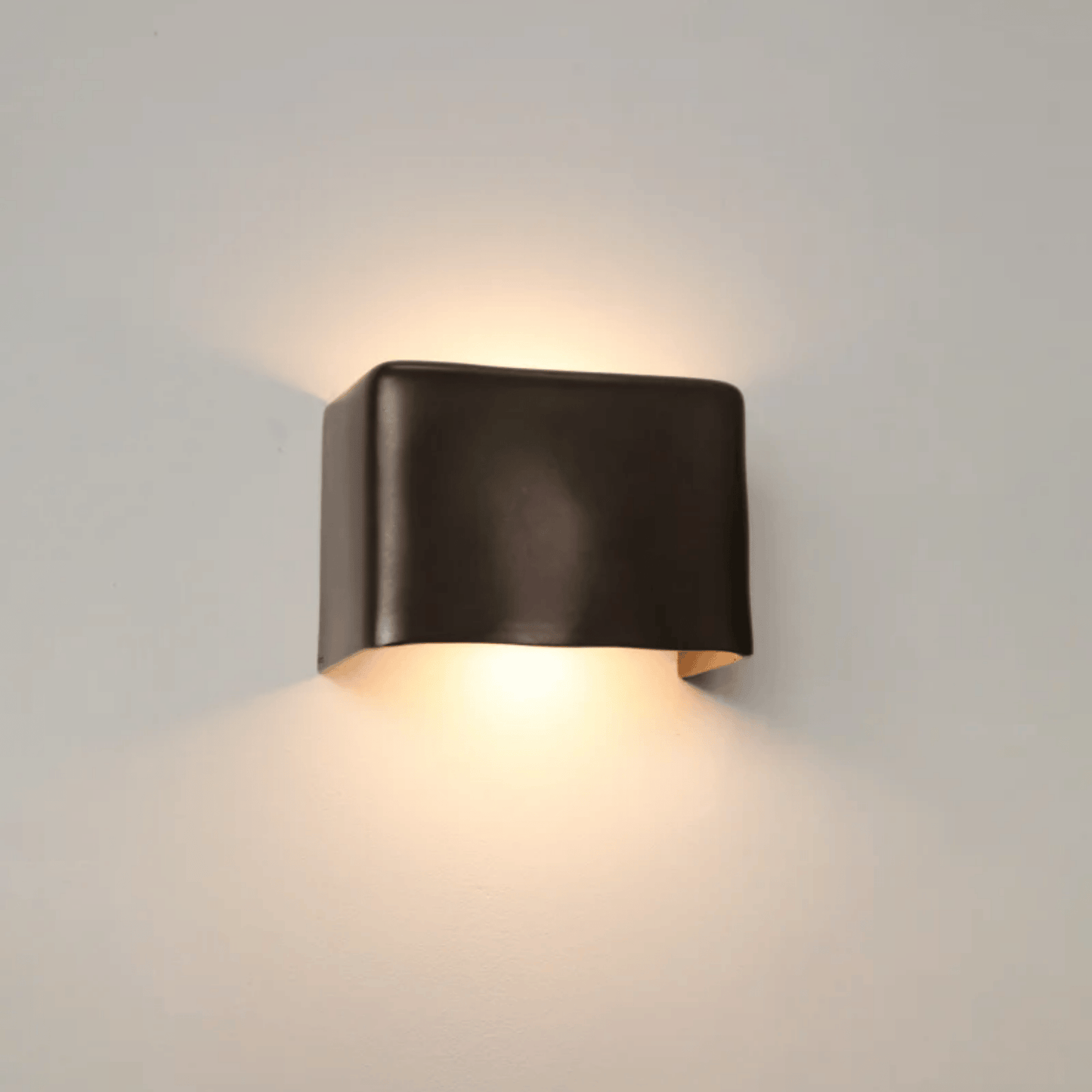 Modern wall-mounted light fixture on a neutral background