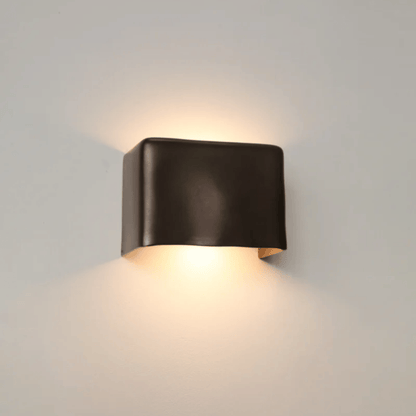 Modern wall-mounted light fixture on a neutral background