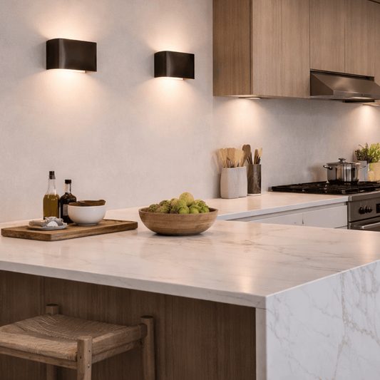 Modern kitchen with marble island, wooden stools, and kitchen utensils.