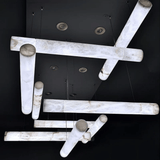 Modern ceiling light fixture with marble-like finish on a black background