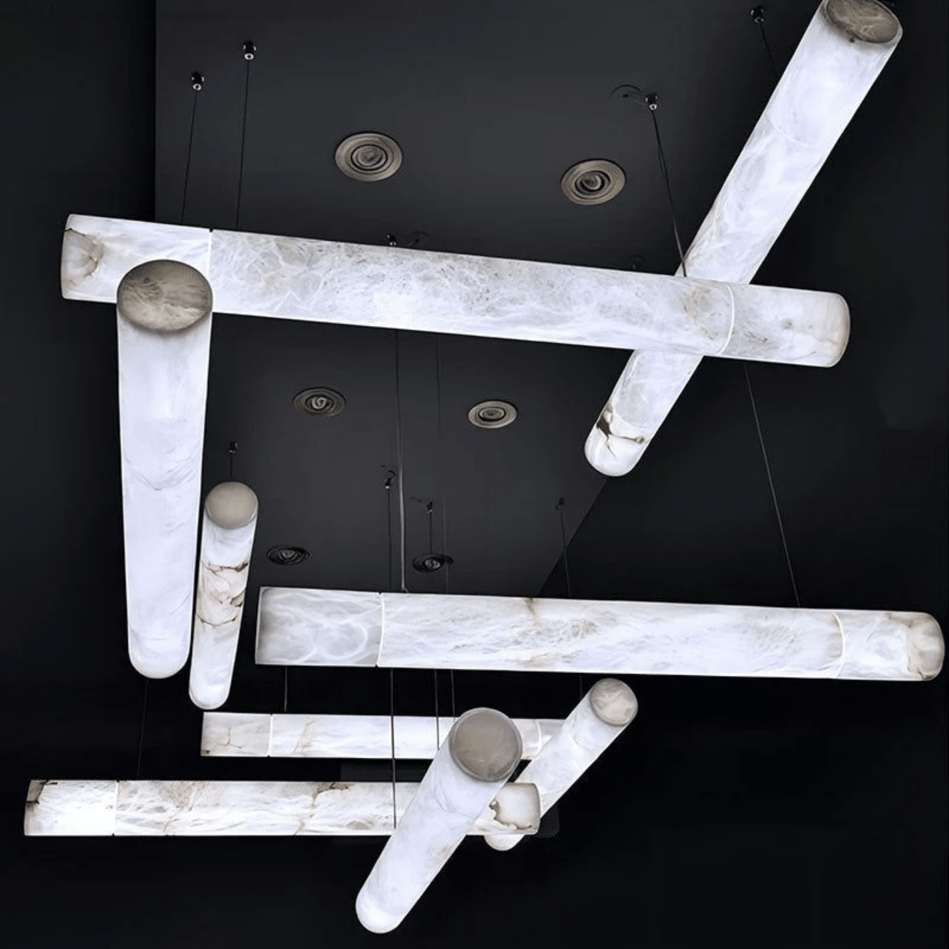 Modern ceiling light fixture with marble-like finish on a black background