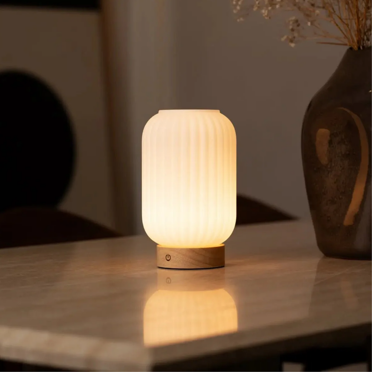Futuristic table lamp with wooden base on a reflective surface