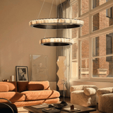 Modern living room with a stylish chandelier, orange sofa, and large windows.