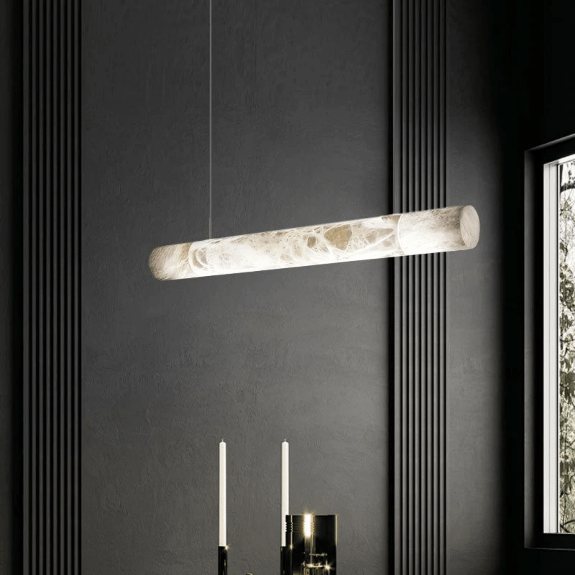 Modern pendant light fixture hanging against a dark wall with a window on the right.