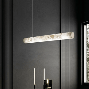 Modern pendant light fixture hanging against a dark wall with a window on the right.