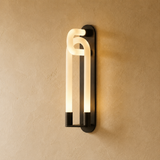Modern wall-mounted light fixture on a beige wall