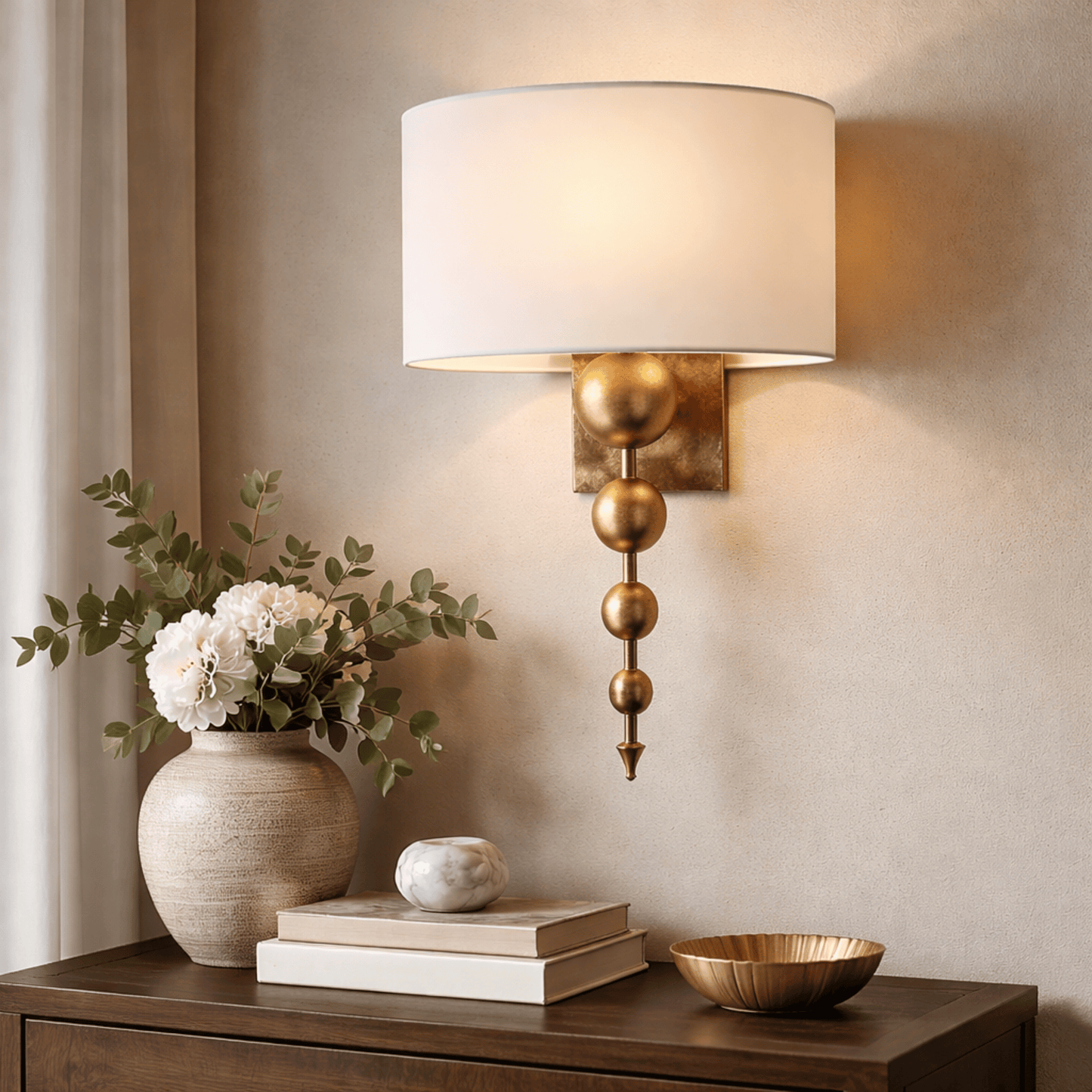 Decorative wall sconce with a vase of flowers and books on a wooden surface.