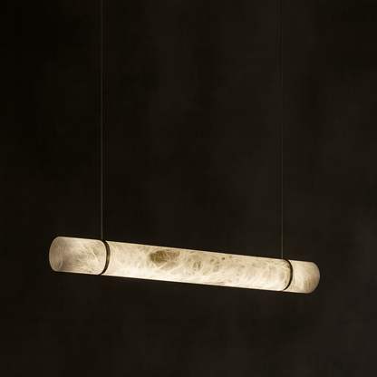 Long cylindrical pendant light on a black background