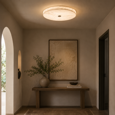 Modern ceiling light fixture in a room with a wooden bench, vase, and abstract painting.