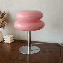 Pink stool with a metallic base on a wooden surface
