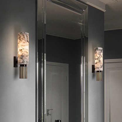 Luxury marble wall sconce with warm LED light and brass accents in modern hallway interior.