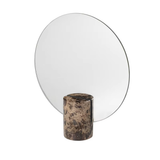 Round mirror with a cylindrical brown base on a white background