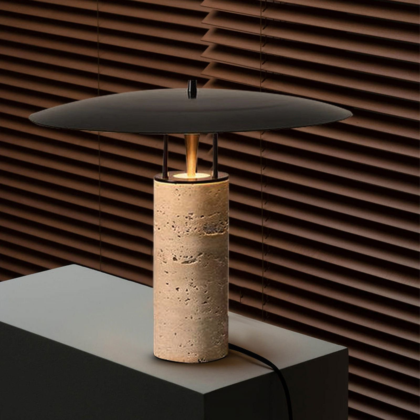 Close-up of a bamboo lamp with a black circular shade placed against a textured wooden wall