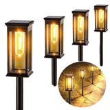Set of four solar-powered outdoor lights with a close-up inset showing their glow on a path.