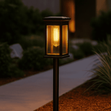 Solar-powered outdoor lamp with warm glow on a garden path