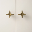 Pair of gold star-shaped earrings on a light background