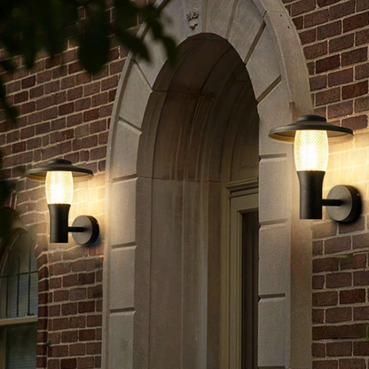 Elegant outdoor wall light mounted beside an arched brick doorway illuminating the entrance