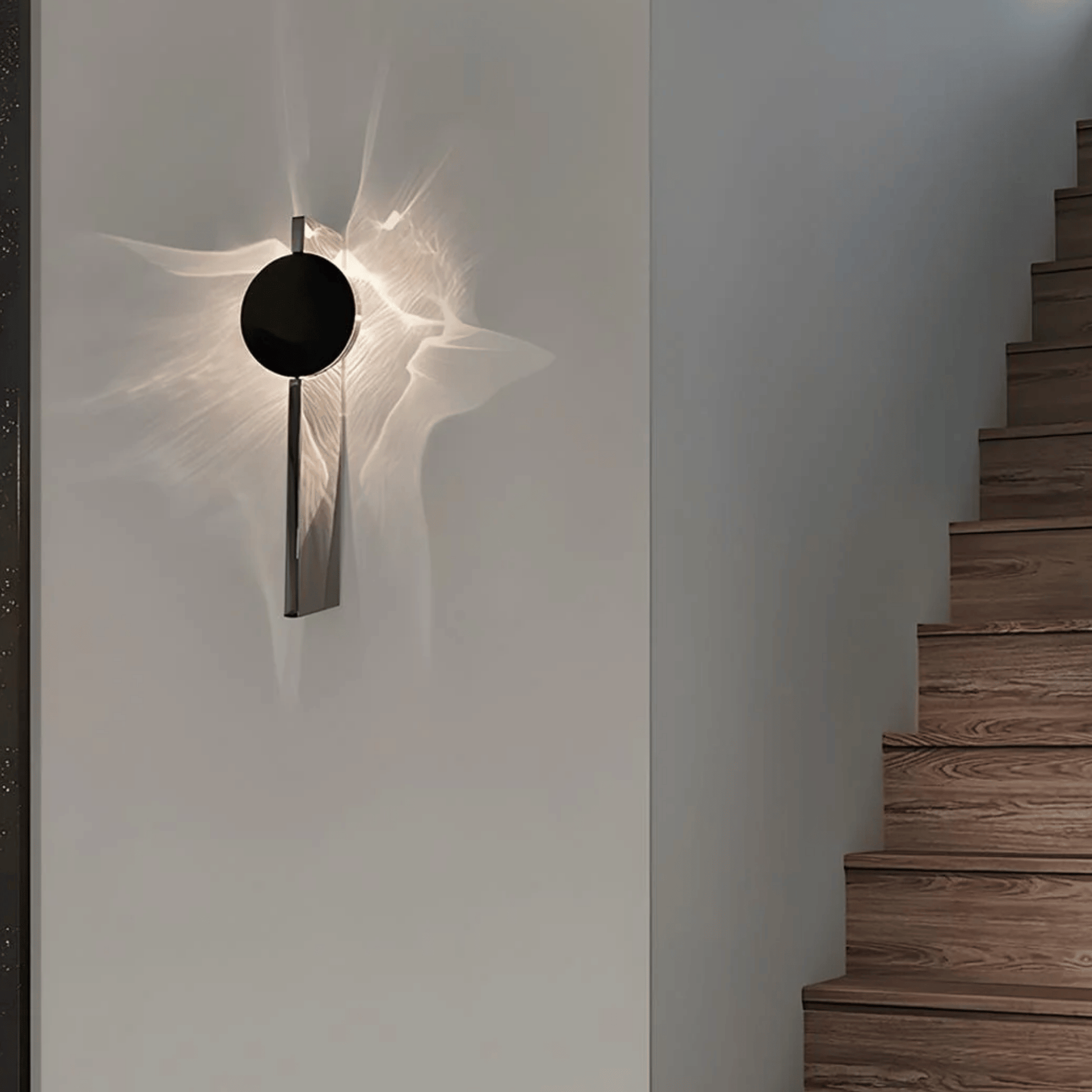 Modern wall sconce on a white wall with wooden stairs in the background