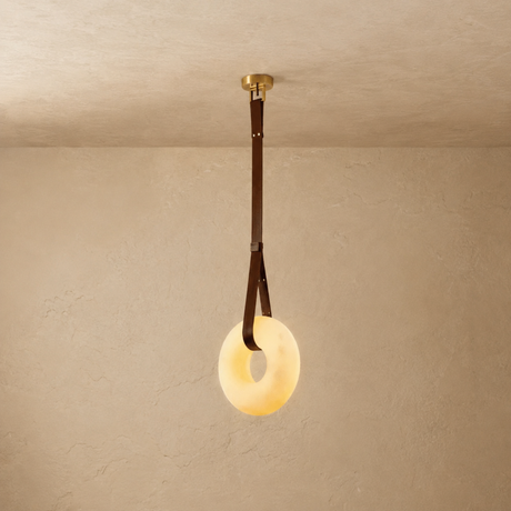 Ceiling light fixture with a round glass shade on a beige wall.