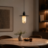 Dining room with a pendant light, table, and decorative items.
