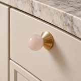 Solvi Brass Ball Cabinet Knobs – Blush Pink – Close-up installed on cream cabinetry