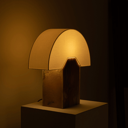 Decorative table lamp with a warm glow on a dark background