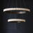 Modern chandelier with two circular designs against a dark background