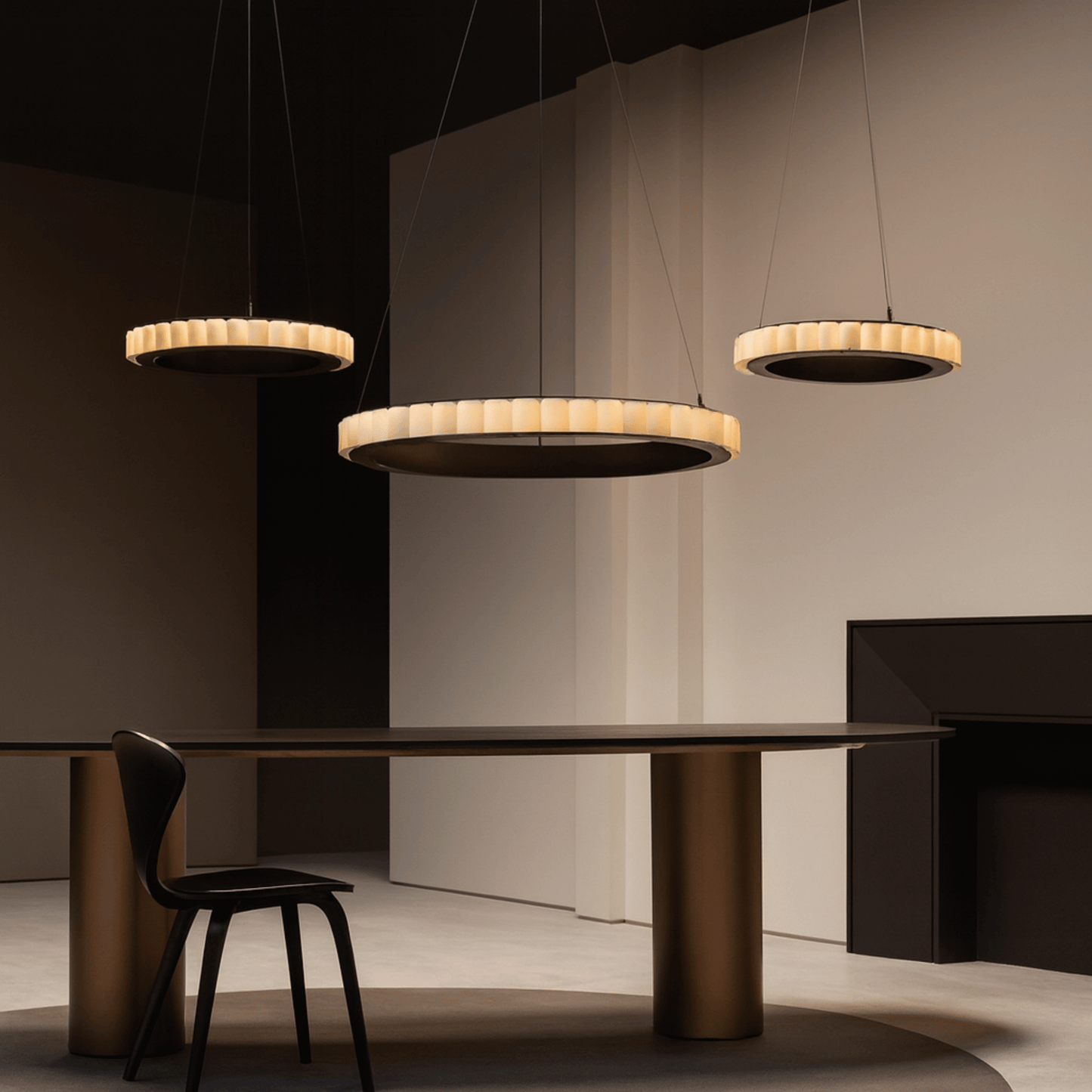 Modern dining room with pendant lights and a table.
