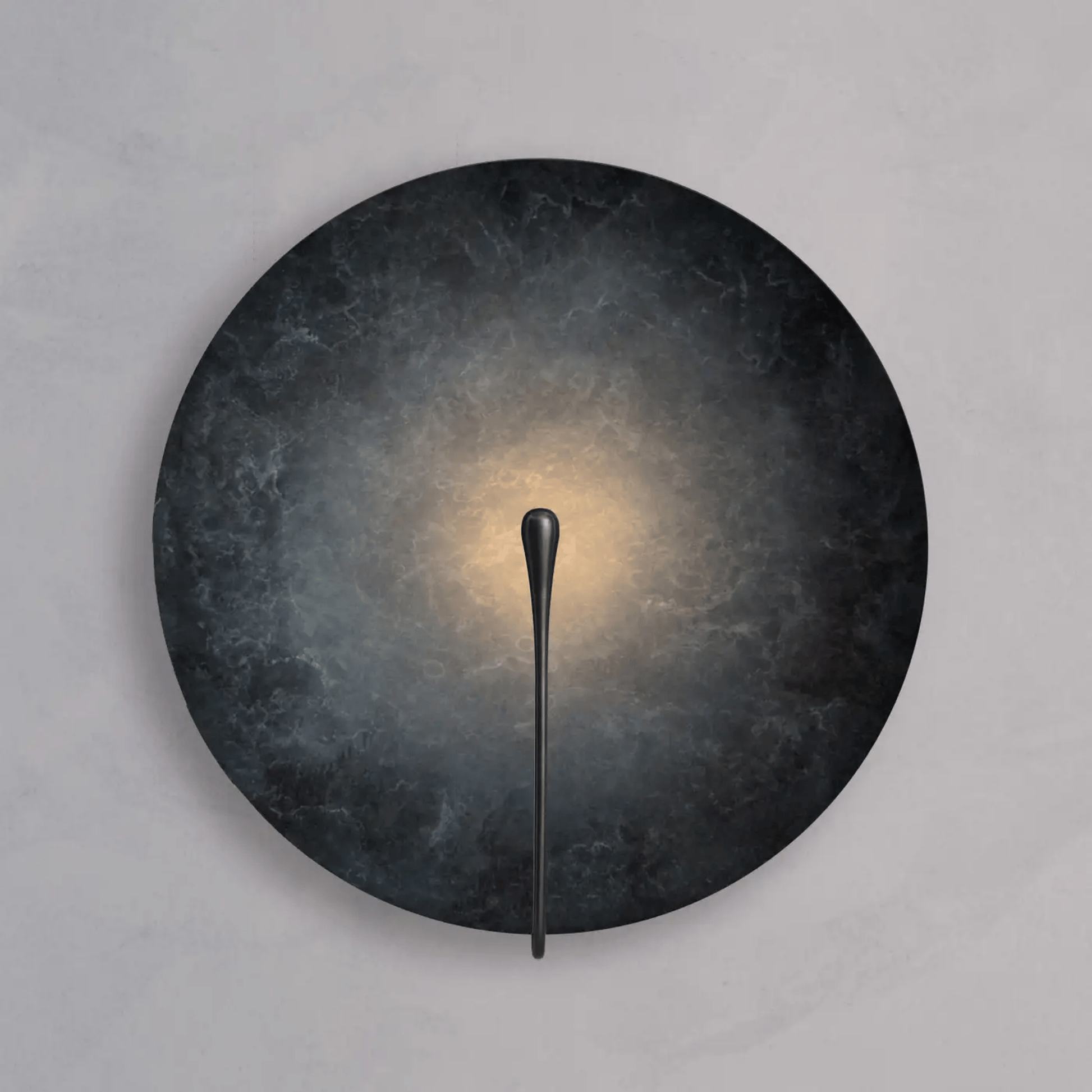 Wall-mounted light fixture with dark circular shade and thin black arm on a gray background